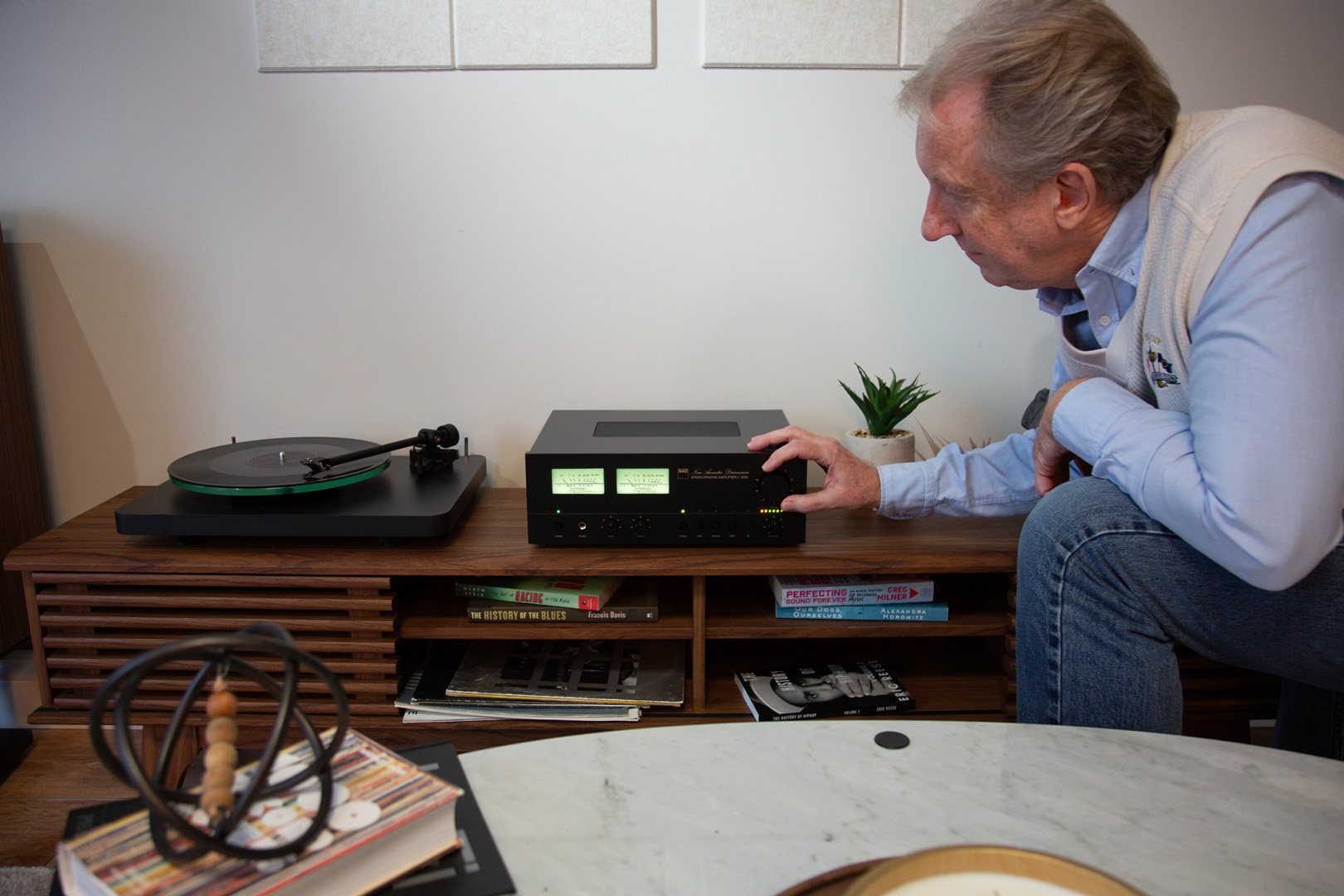 NAD C 3030 with model and hand on Volume Knob